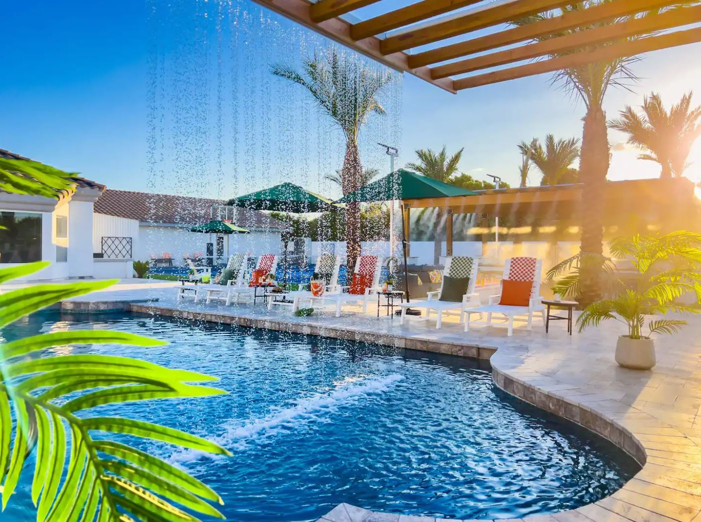 Luxury vacation rental pool with rain-curtain waterfall — a fully designed and built Lifestyle Asset