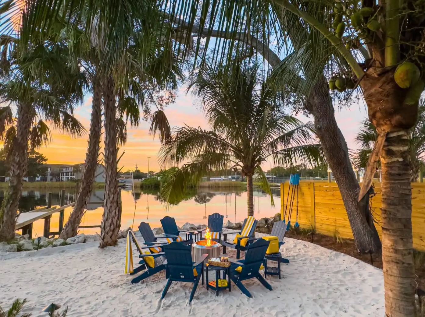 Lakeside fire-pit gathering at sunset — the guest experience that fills the calendar and earns five-star reviews