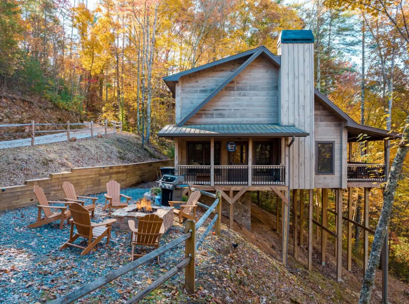 Vodyssey member Lifestyle Asset — modern rustic mountain cabin with fire pit in autumn forest